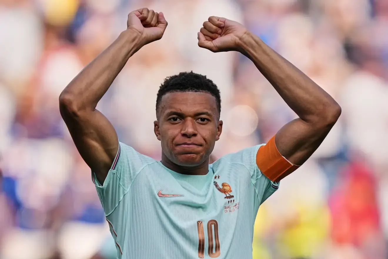 France's Kylian Mbappe (10) celebrates after winning the World Cup quarterfinal soccer match between France and Morocco